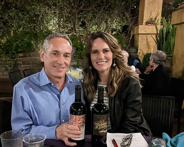 Double door prize winners with their prize of wine